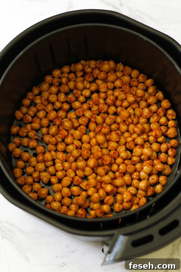 chickpeas in an air fryer basket.