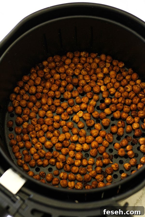 crispy chickpeas in an air fryer basket.