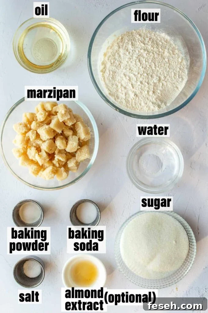 A labelled picture of ingredients including oil, flour, marzipan, water, baking powder, baking soda, salt, sugar and optional almond extract.