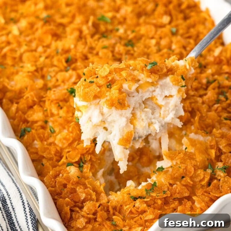 A close-up of a Hash Brown Casserole with a golden, cornflake topping.