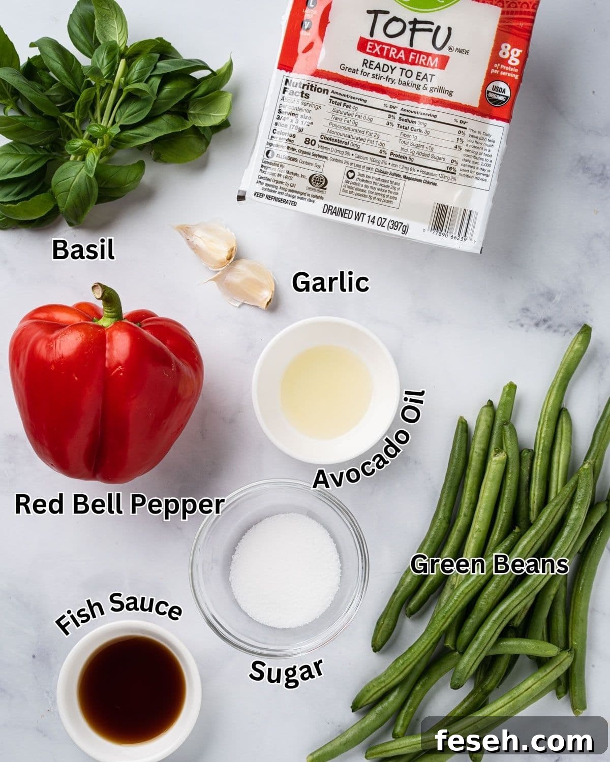 Ingredients needed for tofu pad krapow: extra firm tofu, basil, garlic, red bell peppers, green beans, avocado oil, fish sauce, soy sauce, and sugar.