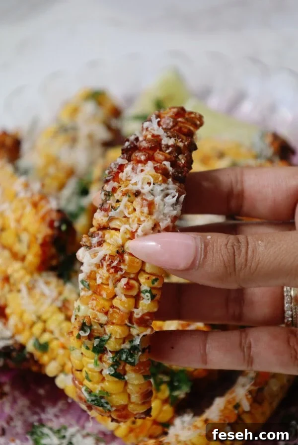 Spicy Honey Mozzarella Sticks Recipe (Video Included) 12 A corn rib quarter is held in someone's hand.