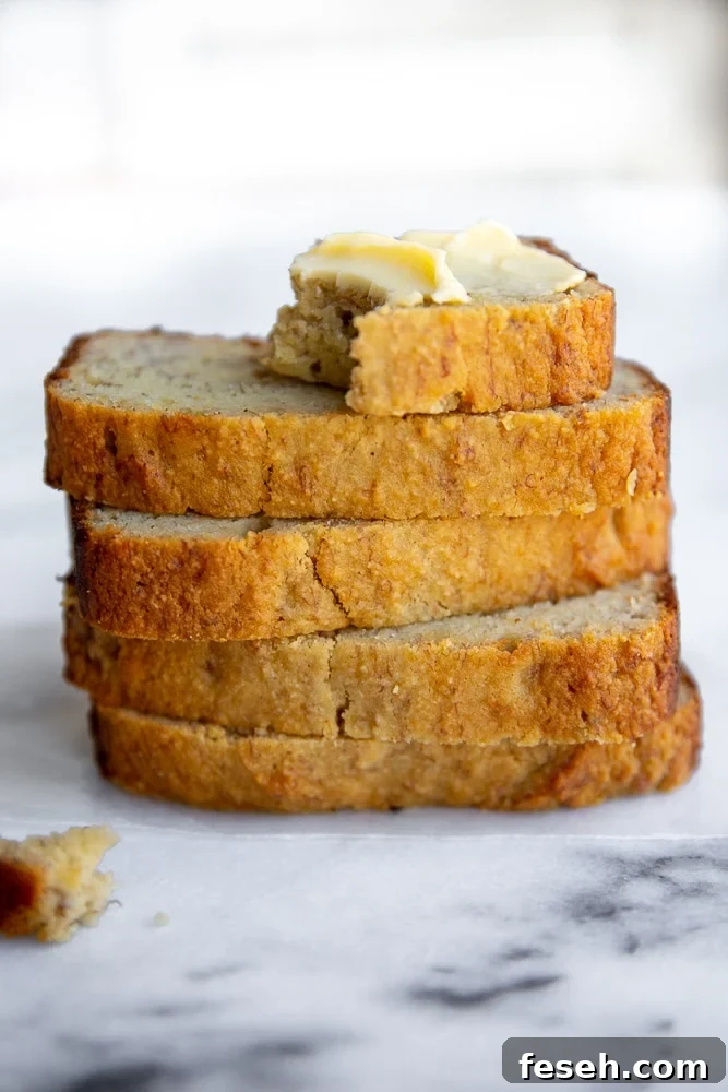 Gluten free banana bread stacked on counter.