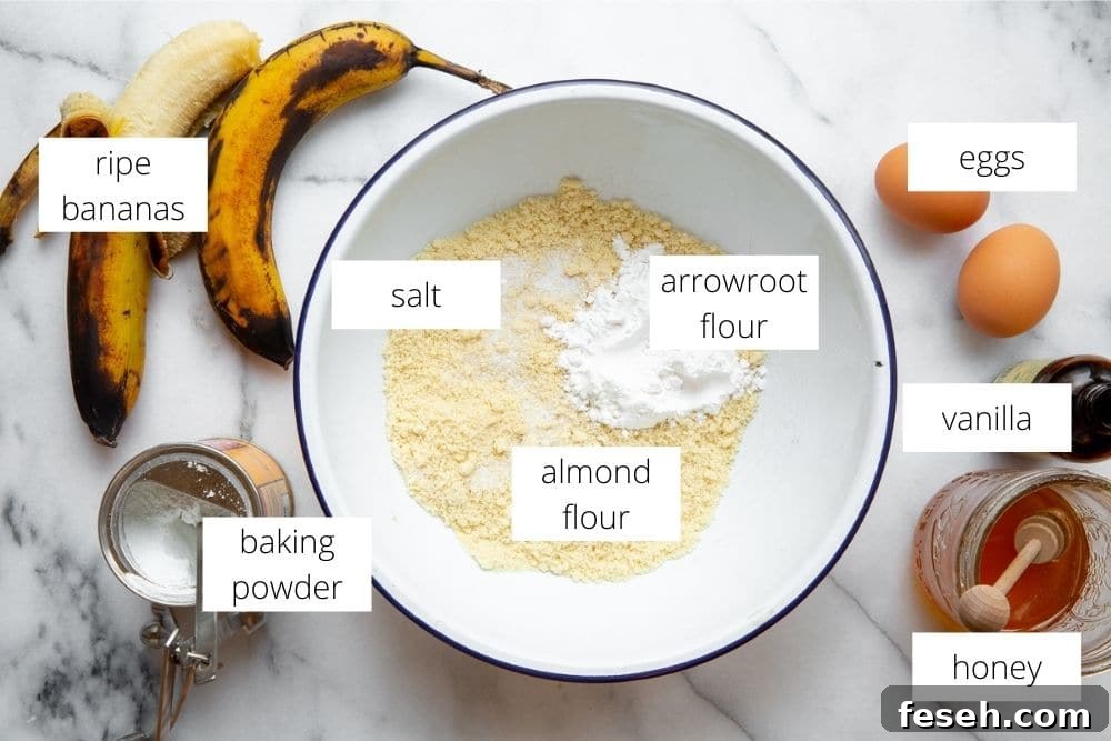 The ingredients for the gluten free banana bread recipe arranged on a marble surface with labels.