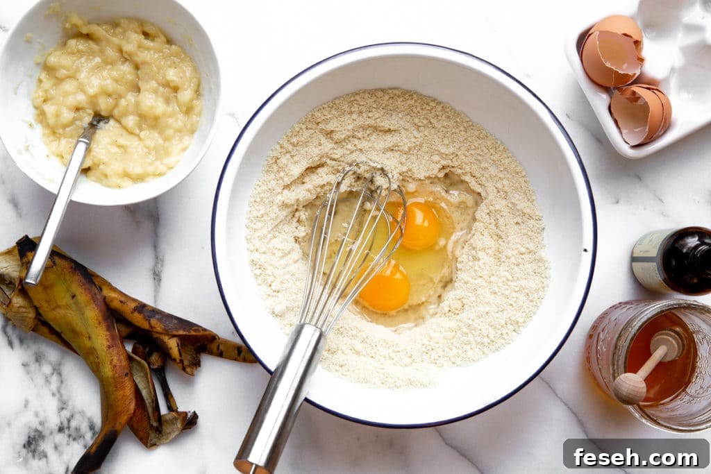 Process shot showing eggs getting mixed into the dry ingredients.