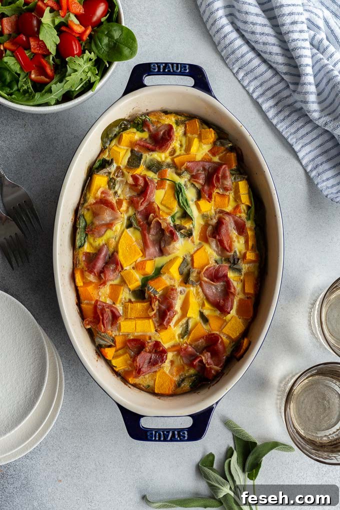 Overhead view of butternut squash quiche in an oval dish.