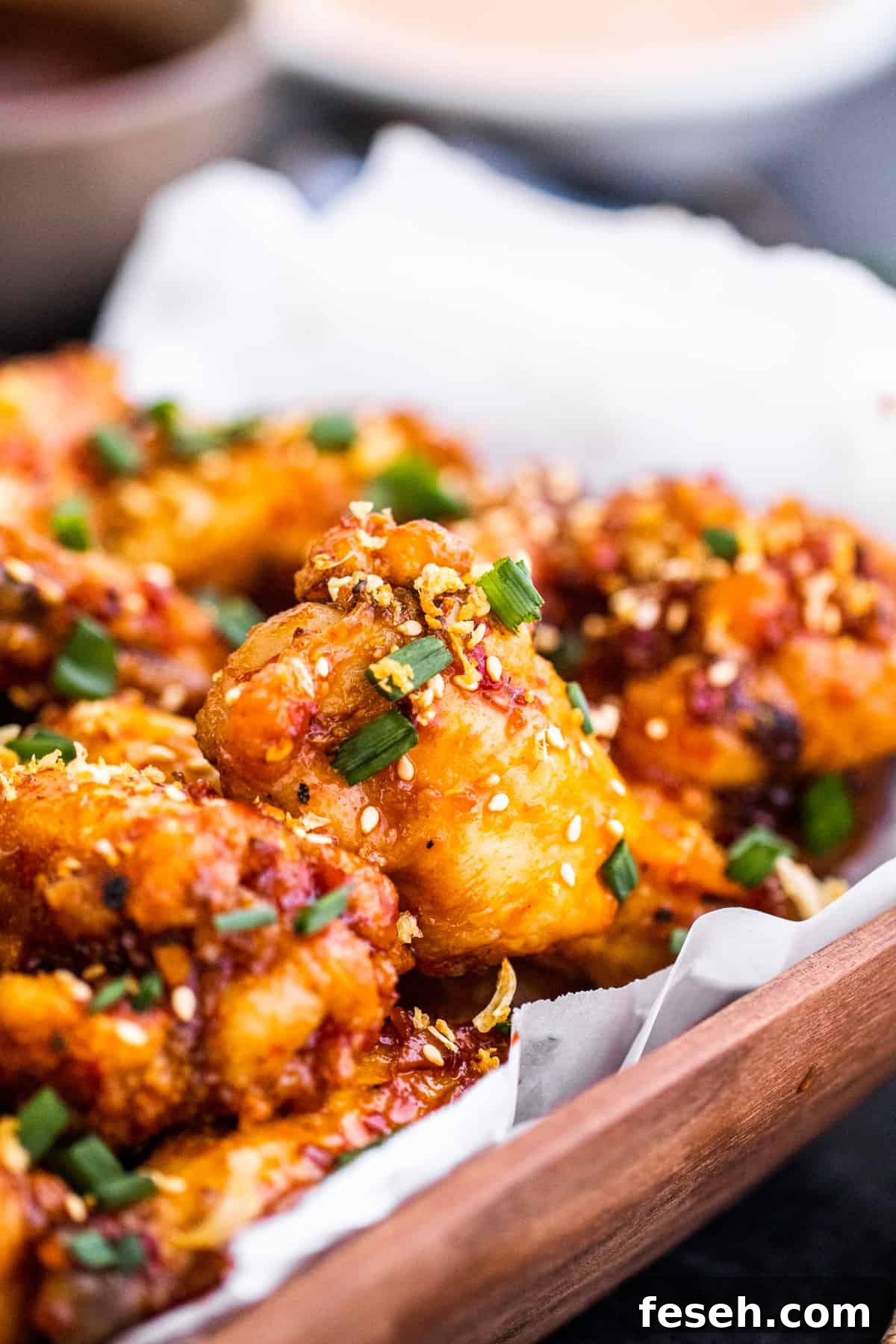 Angle shot close up of bowl of chicken wings.
