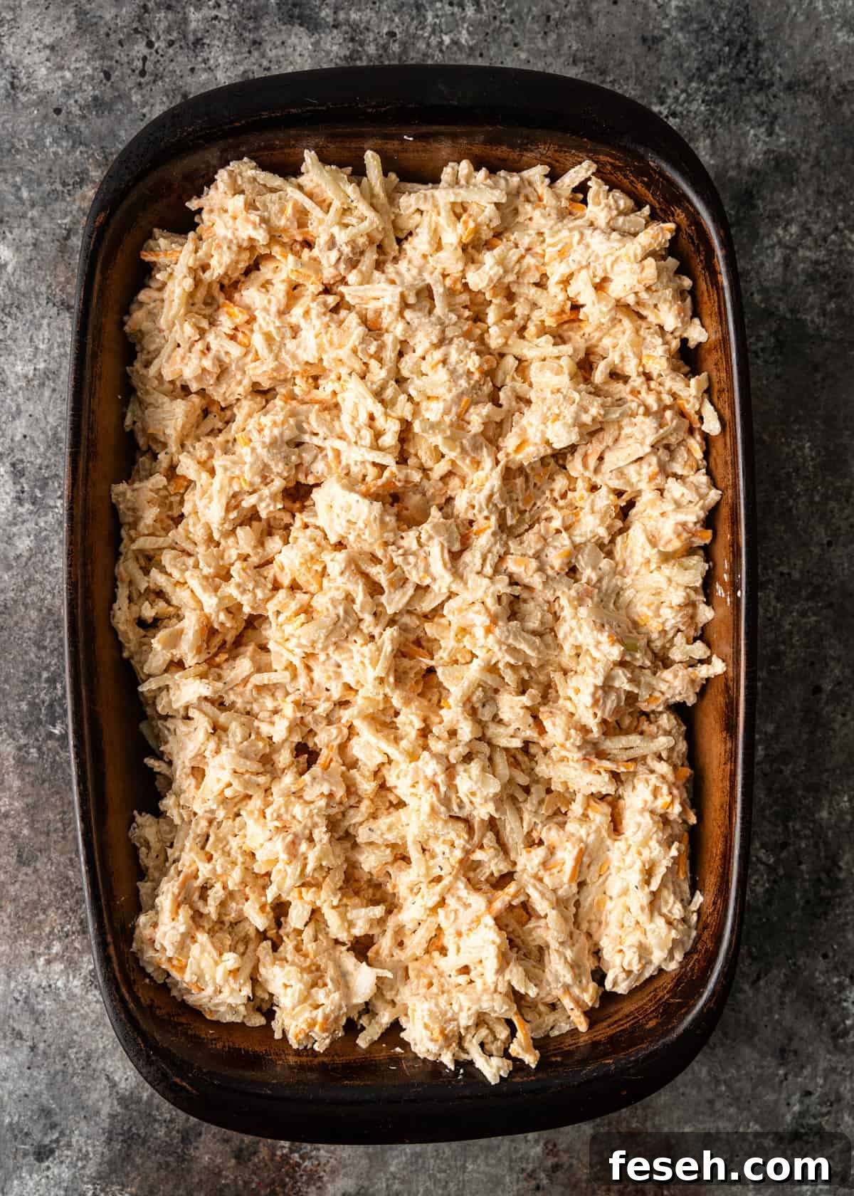 Southern Hashbrown Casserole Recipe for Comforting Family Dinners 6 overhead: hashbrown casserole in a casserole dish before baking