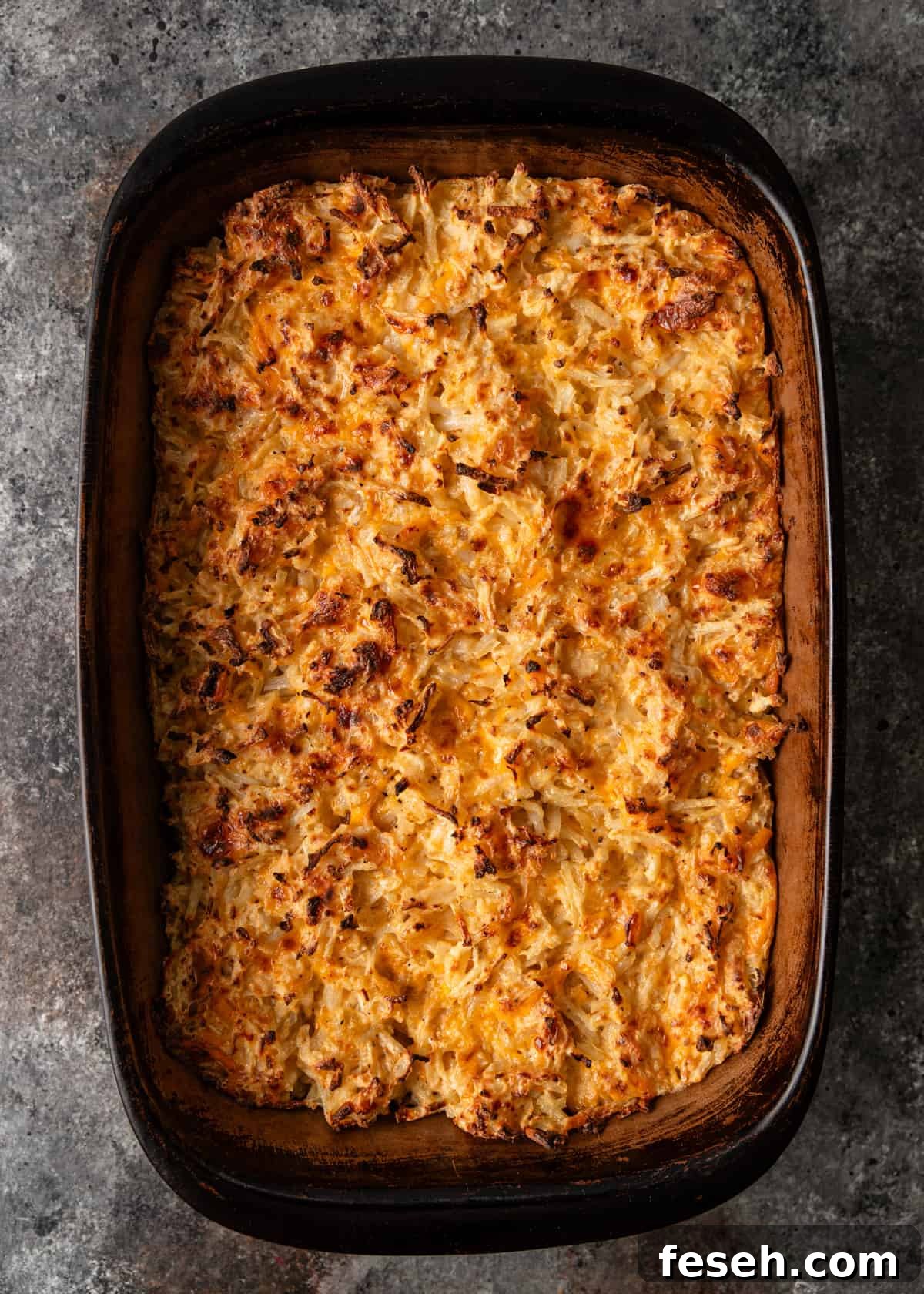 Southern Hashbrown Casserole Recipe for Comforting Family Dinners 7 overhead: hashbrown casserole in a casserole dish after baking