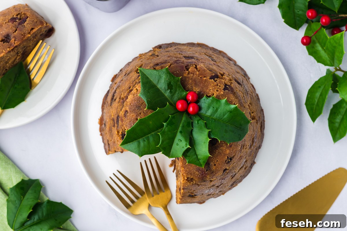 Slow cooker figgy pudding on a plate with a piece missing and two forks.
