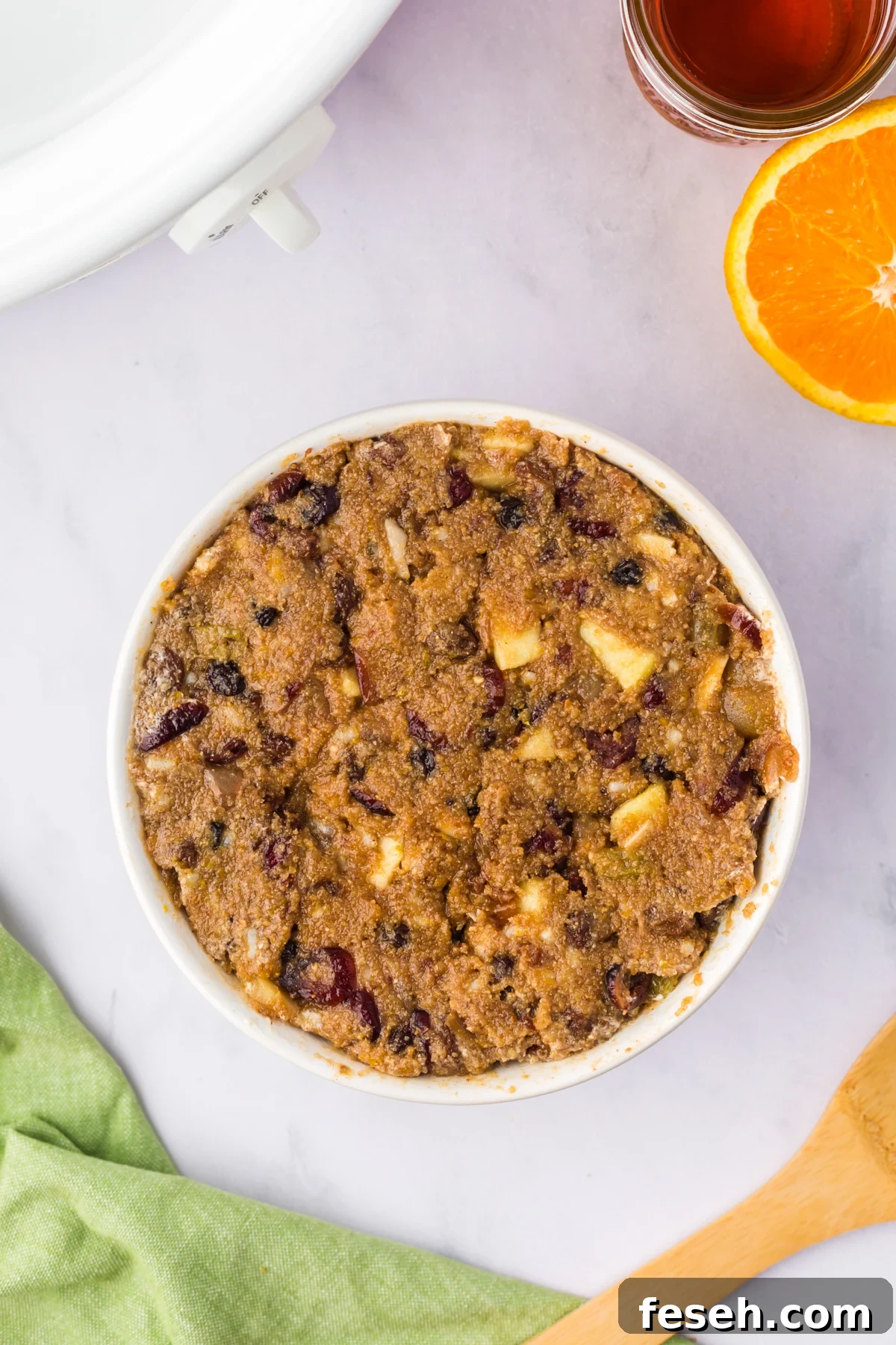 Figgy pudding mixture in a white pudding basin.