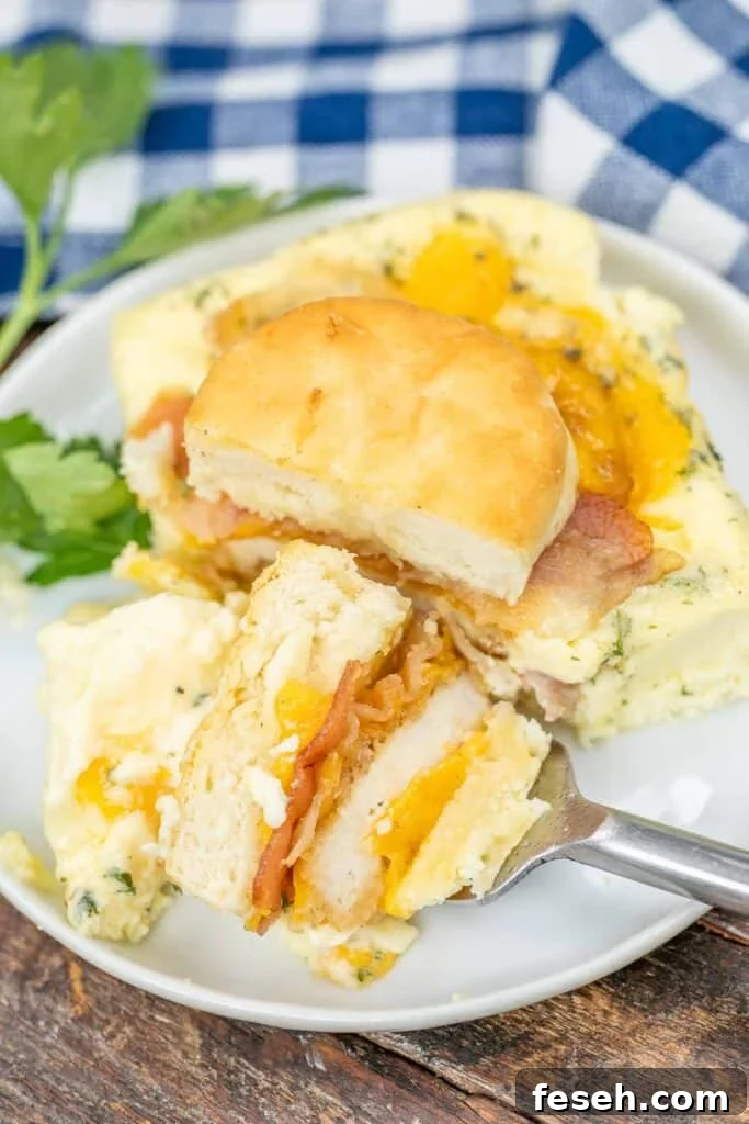 cutting into a chicken biscuit on a plate