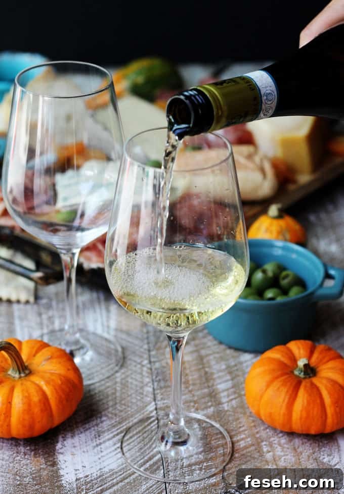 Pouring white Italian wine into a glass