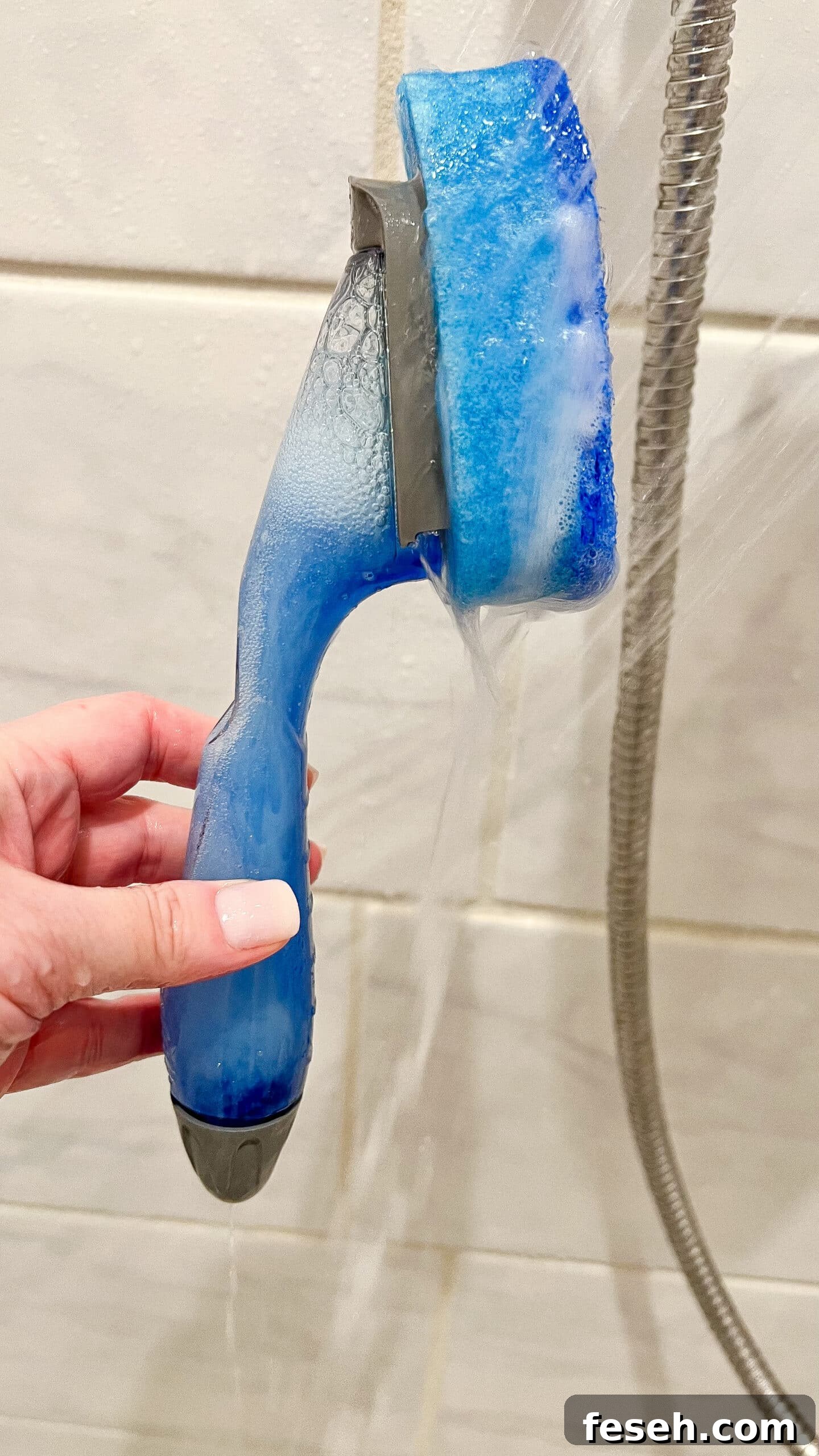 hand holding homemade shower cleaner
