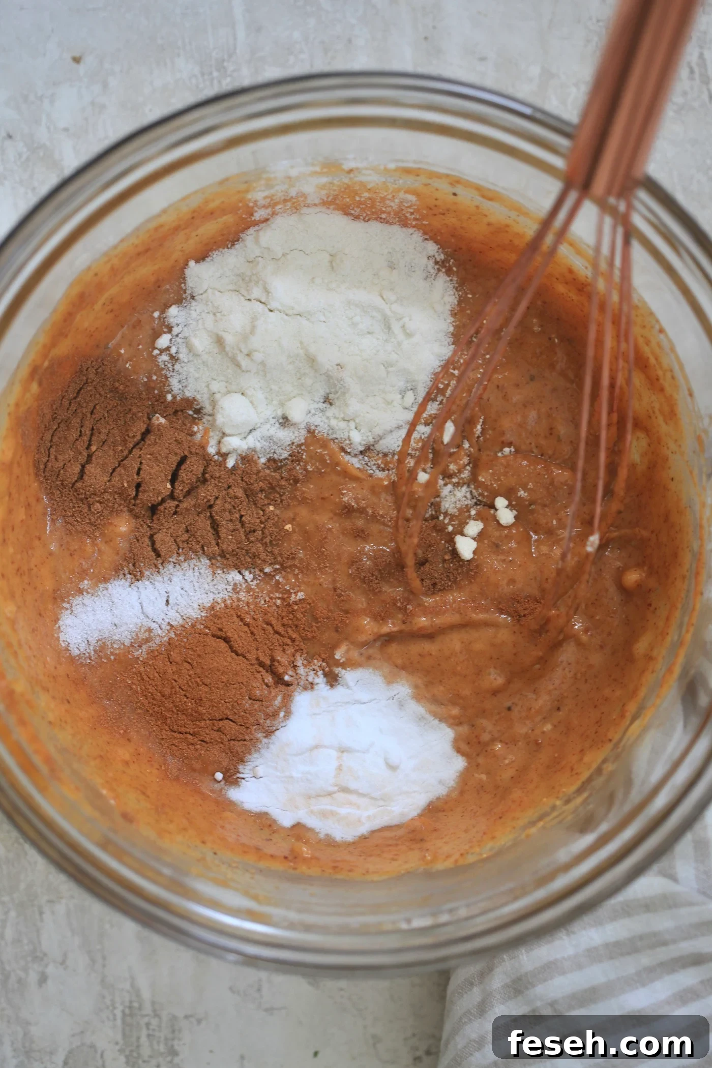 mixing bowl with pumpkin batter and coconut flour
