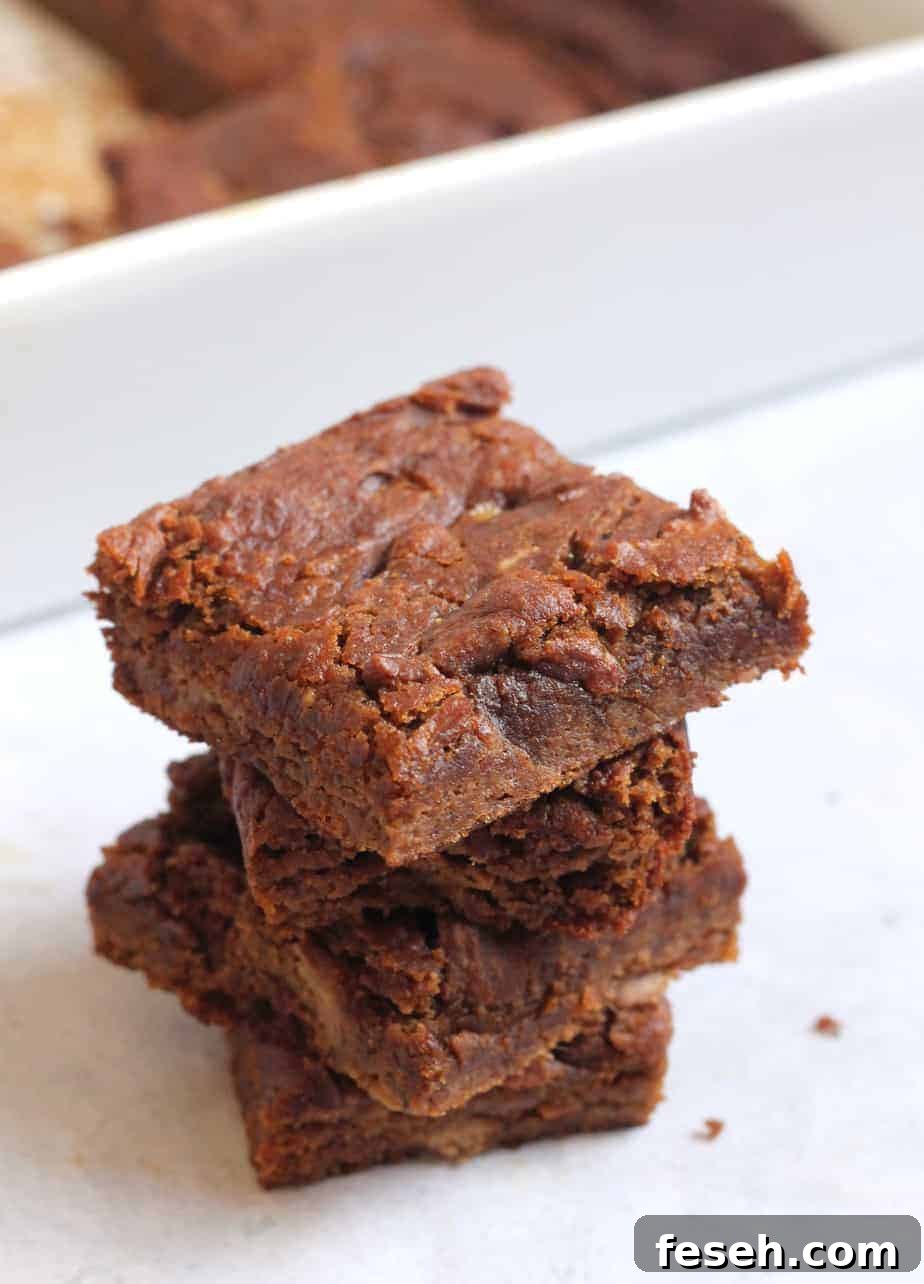 pumpkin bars stacked next to white dish