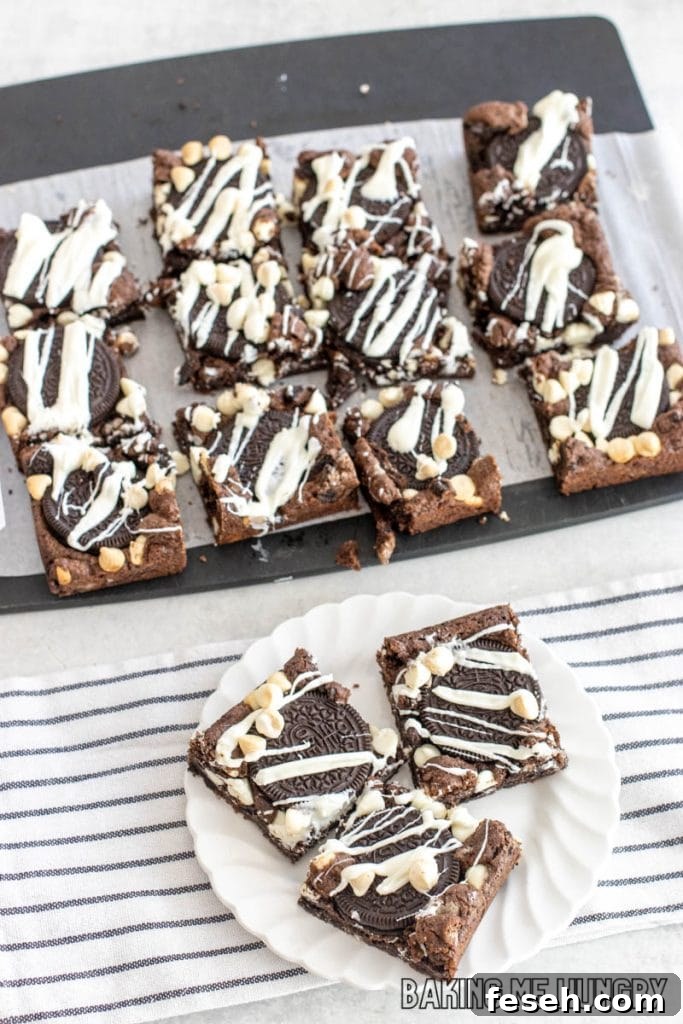 cookies and cream cookie bars on small plate with remaining bars on cutting board