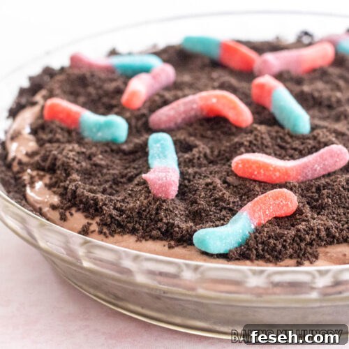 mud pie recipe with gummy worms shown close up in glass pie plate