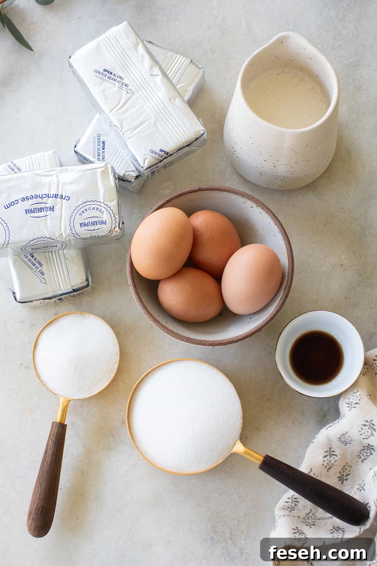 ingredients on a table to make a Bailey's Irish Cream cheesecake recipe.