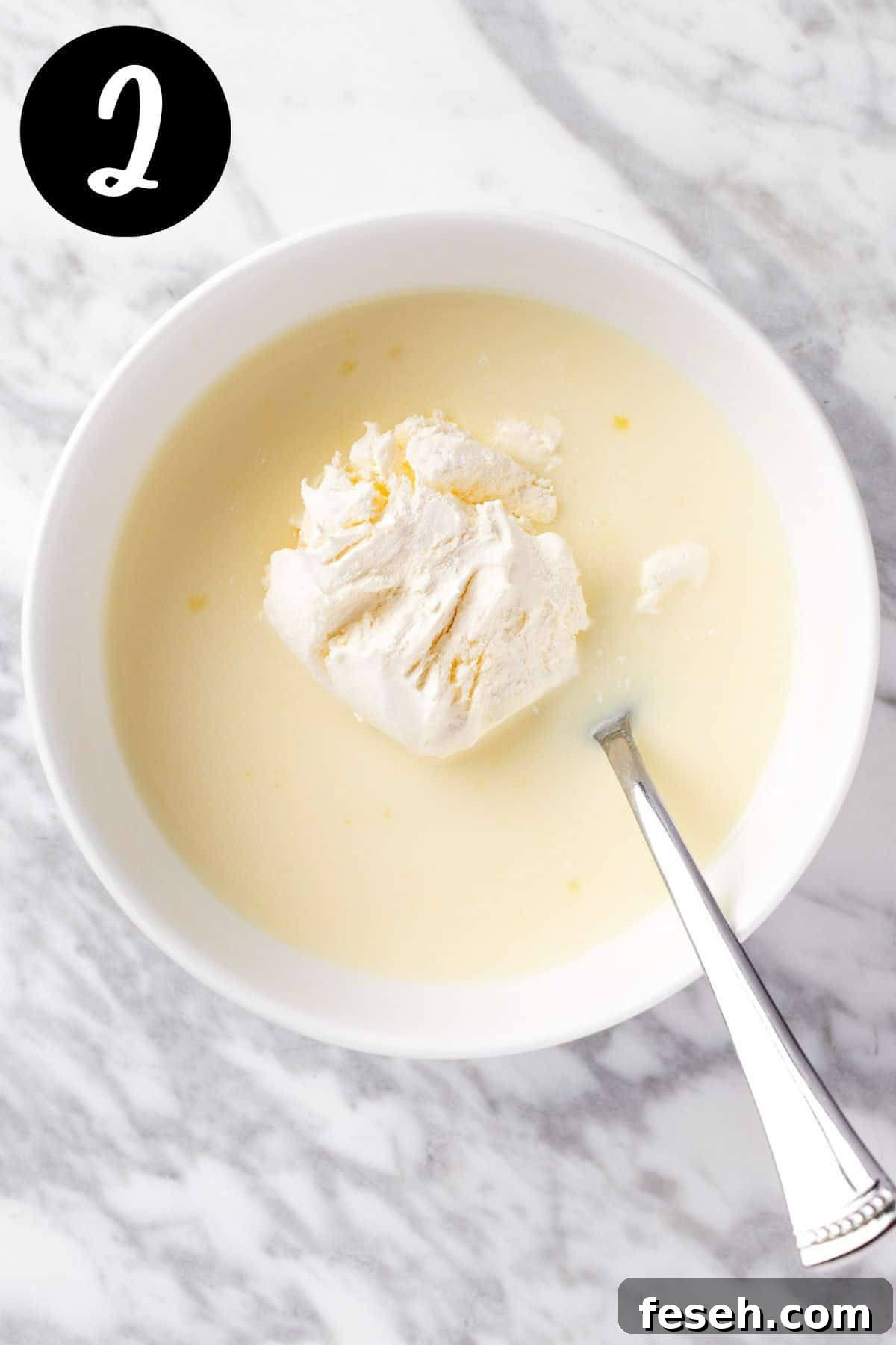 Folding the cool whip into the pudding mixture.