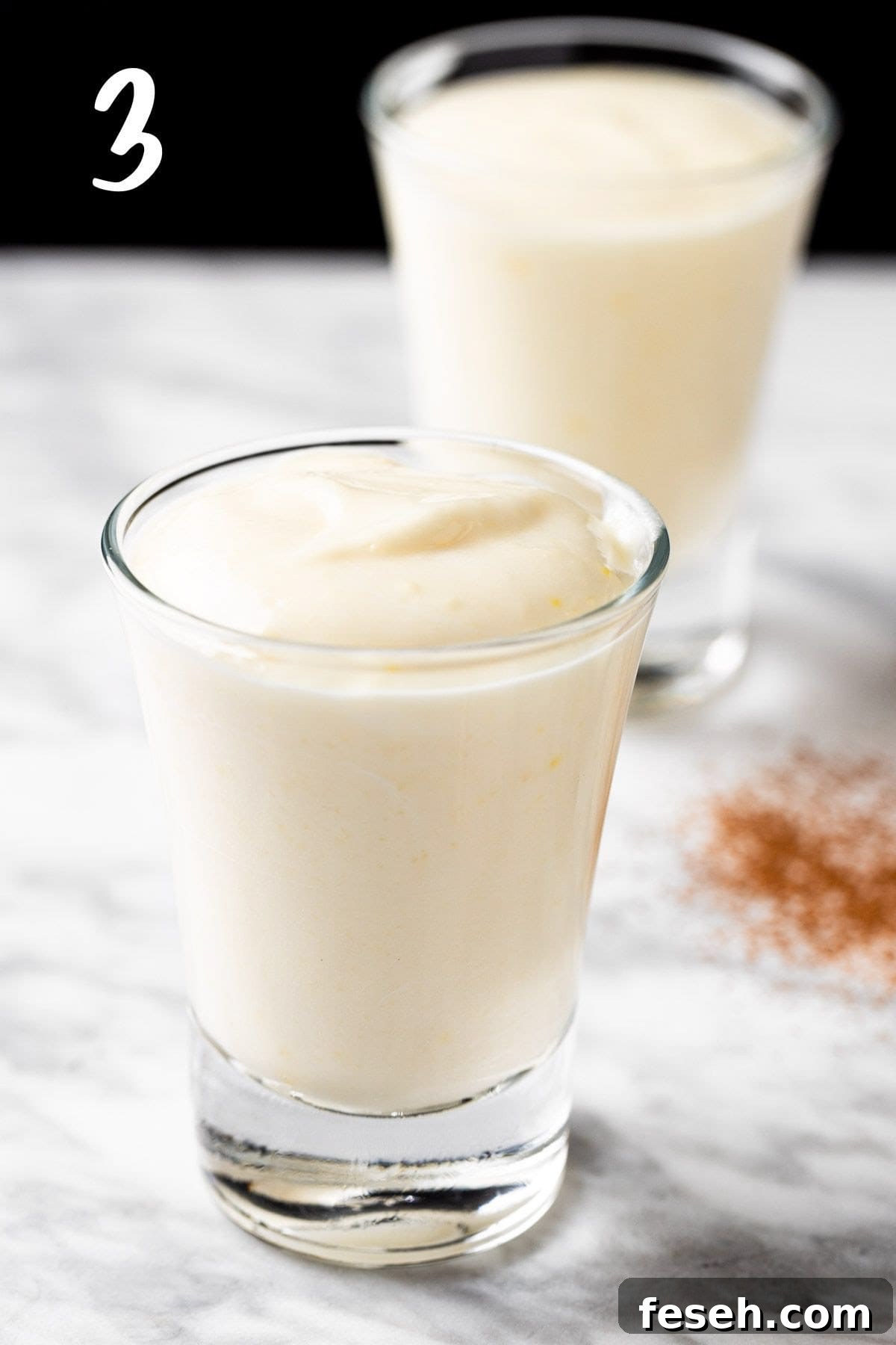 Dividing the vanilla pudding into shot glasses.