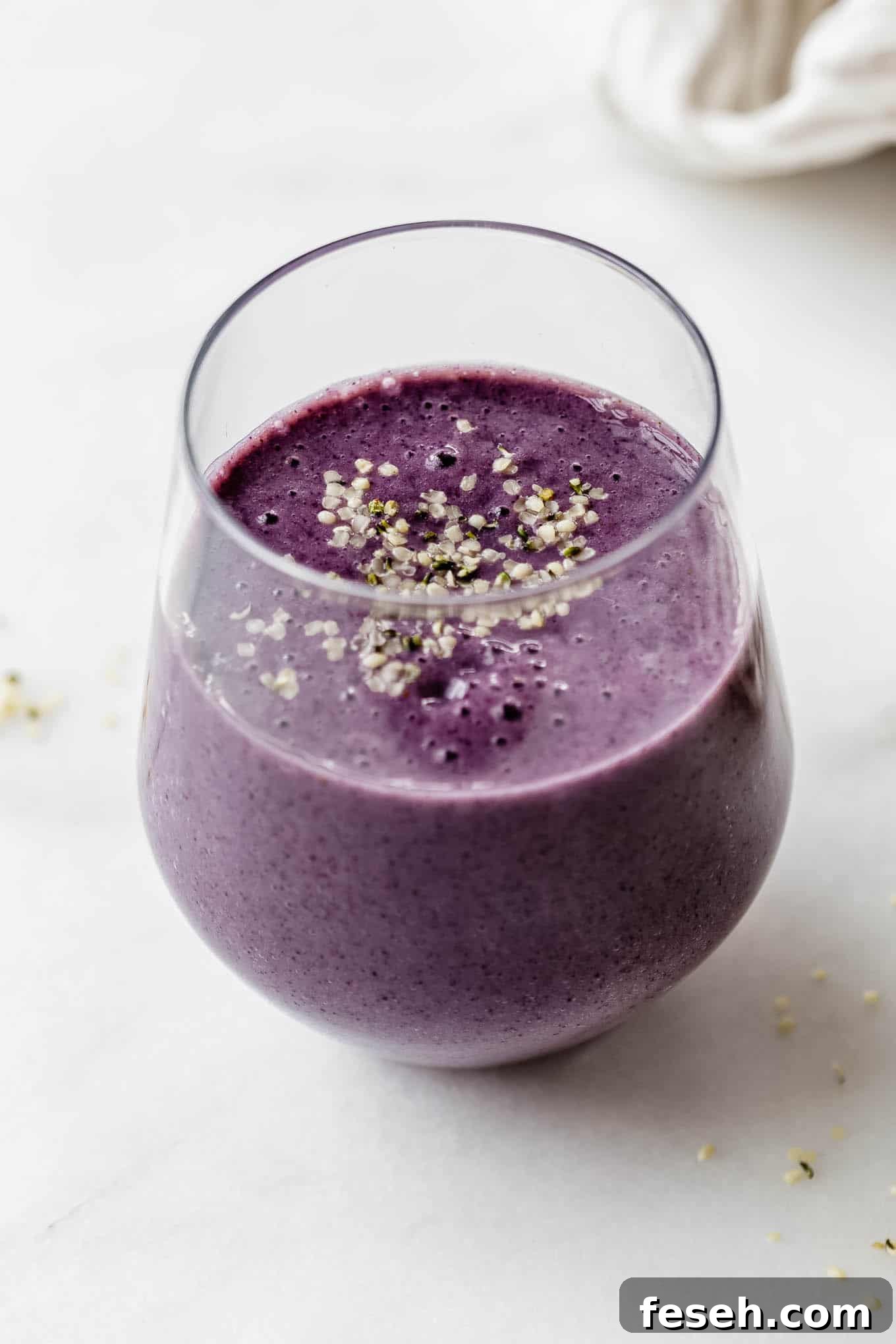 A blueberry avocado smoothie topped with hemp seeds