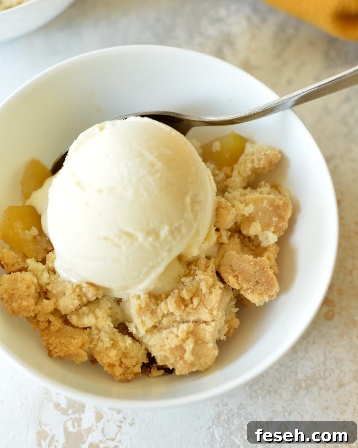 Crispy Apple Crisp (Oat-Free) Recipe for Homemade Dessert 7 a bowl of apple crisp with vanilla ice cream