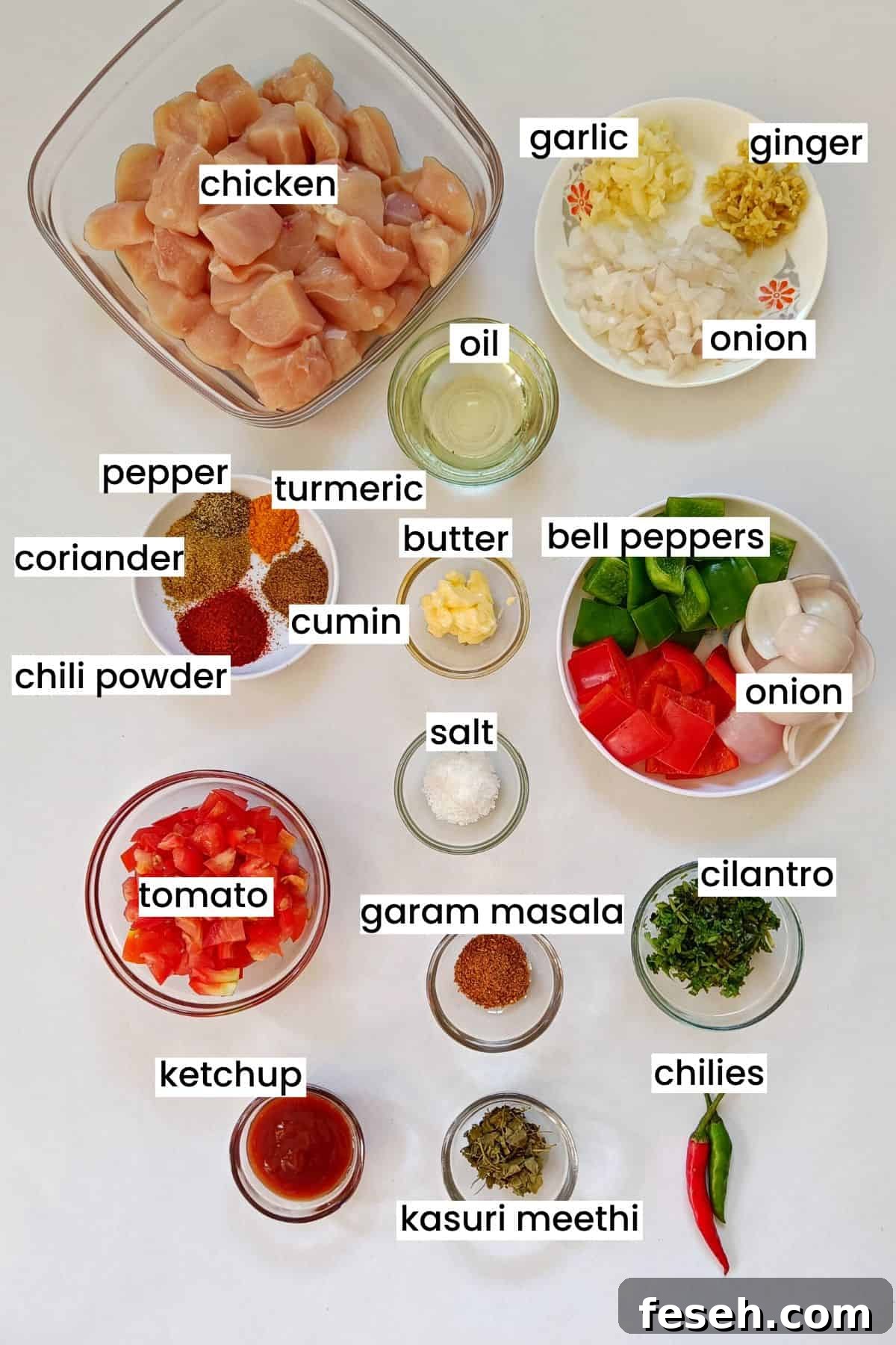 Image showing chicken jalfrezi ingredients placed on a white background.
