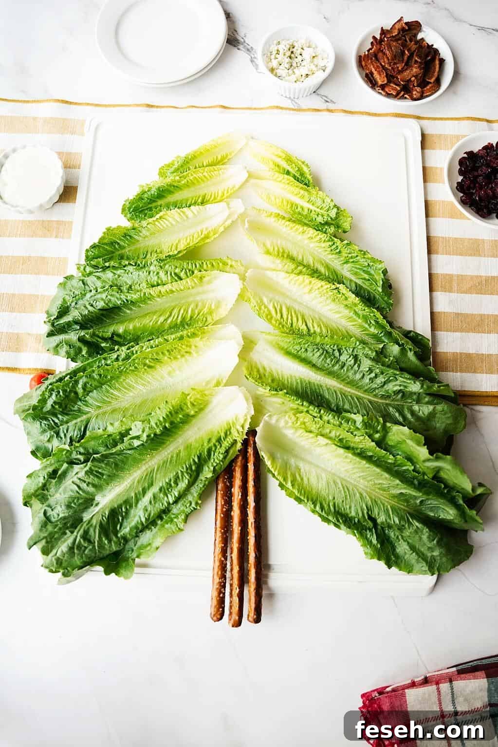 Romaine cups layed out to form a tree on a white board
