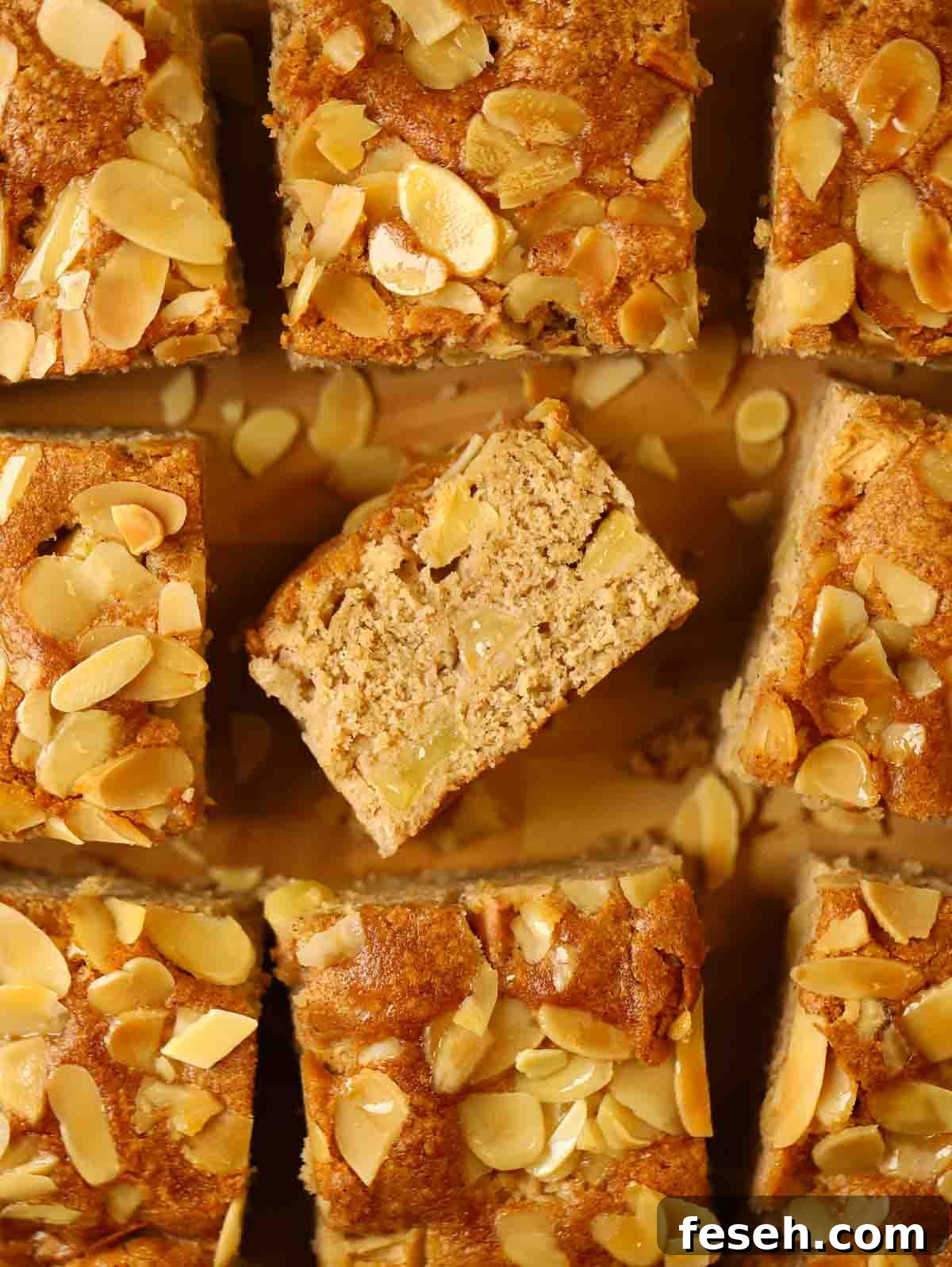 Squares of apple cake with one in the middle on its side to show the middle.