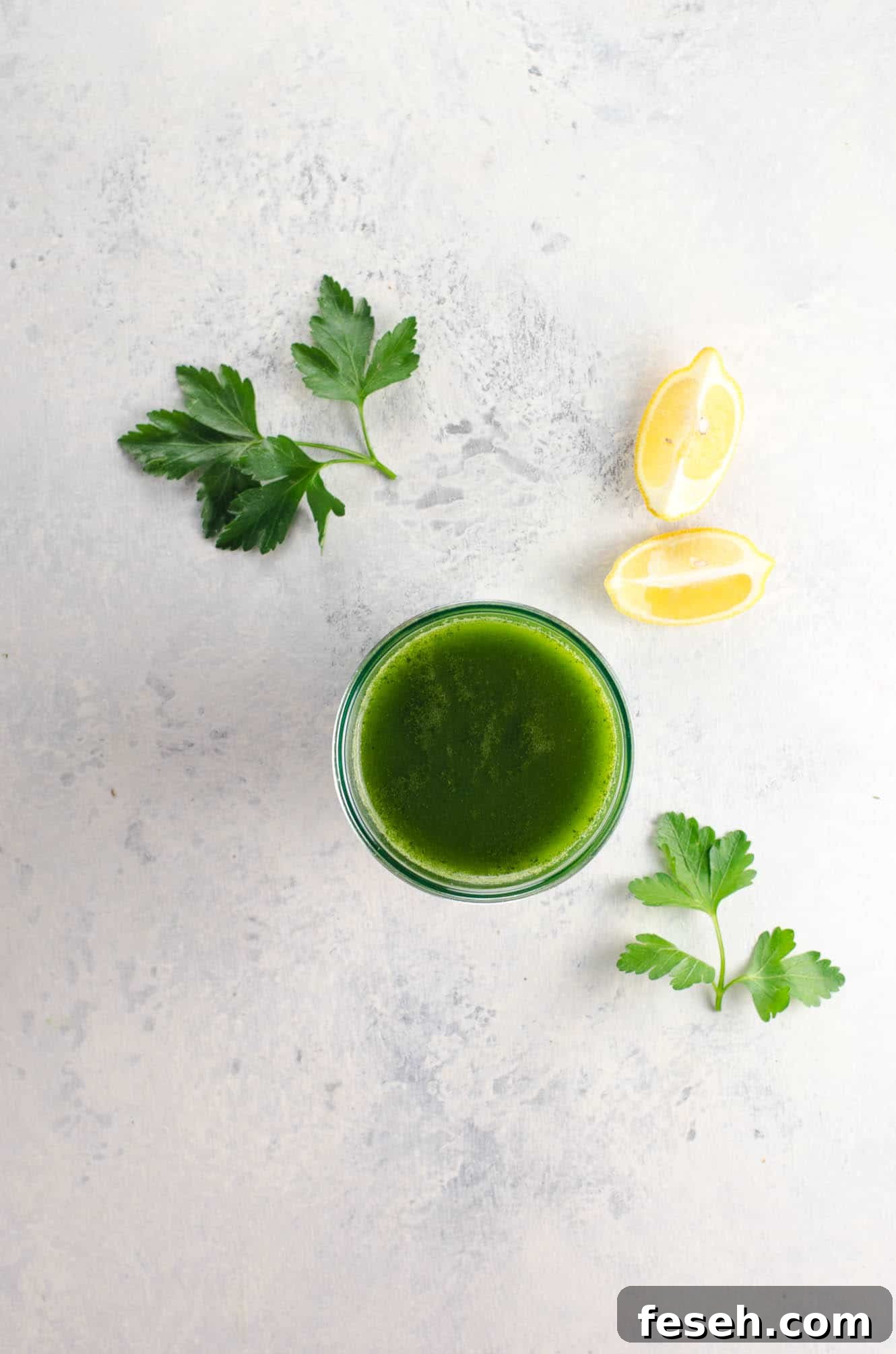 Green Juice Recipes to Support Weight Loss and Boost Metabolism 5 a lovable green juice for weight loss in a glass with parsley and lemon wedges