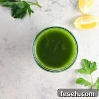 Green Juice Recipes to Support Weight Loss and Boost Metabolism 6 a lovable green juice for weight loss in a glass with parsley and lemon wedges