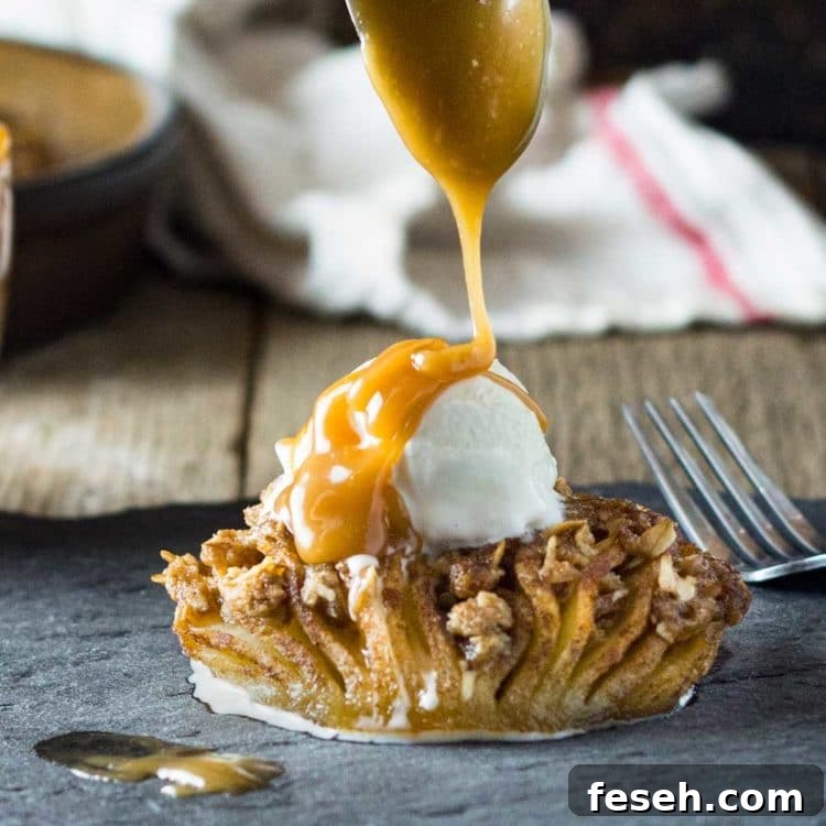 close up: spooning caramel sauce over ice cream on baked apple dessert