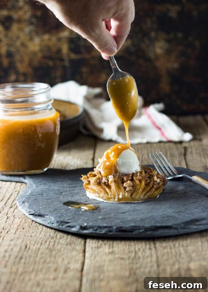 drizzling caramel over vanilla ice cream on stuffed baked cinnamon apple