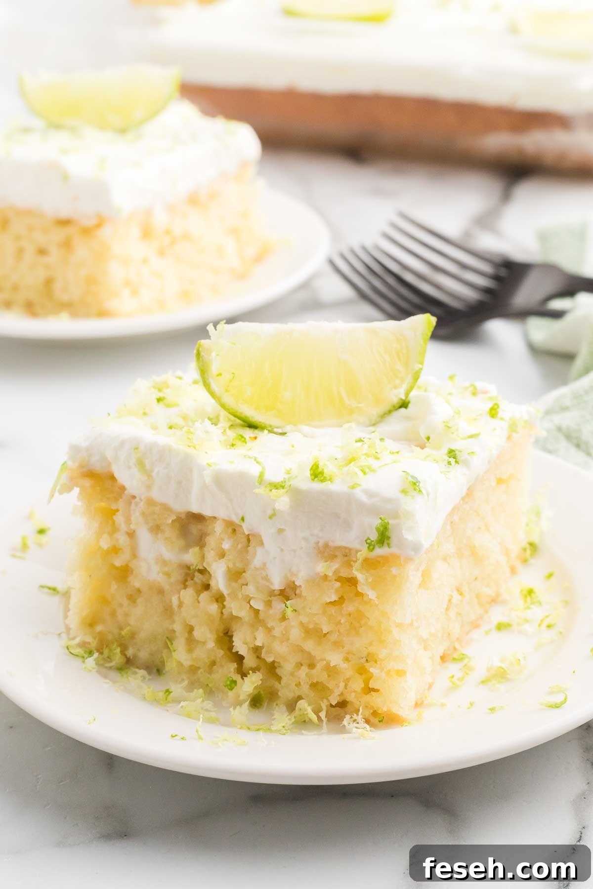 Margarita Poke Cake Recipe with Lime and Tequila 2 Slice of margarita poke cake on a plate.