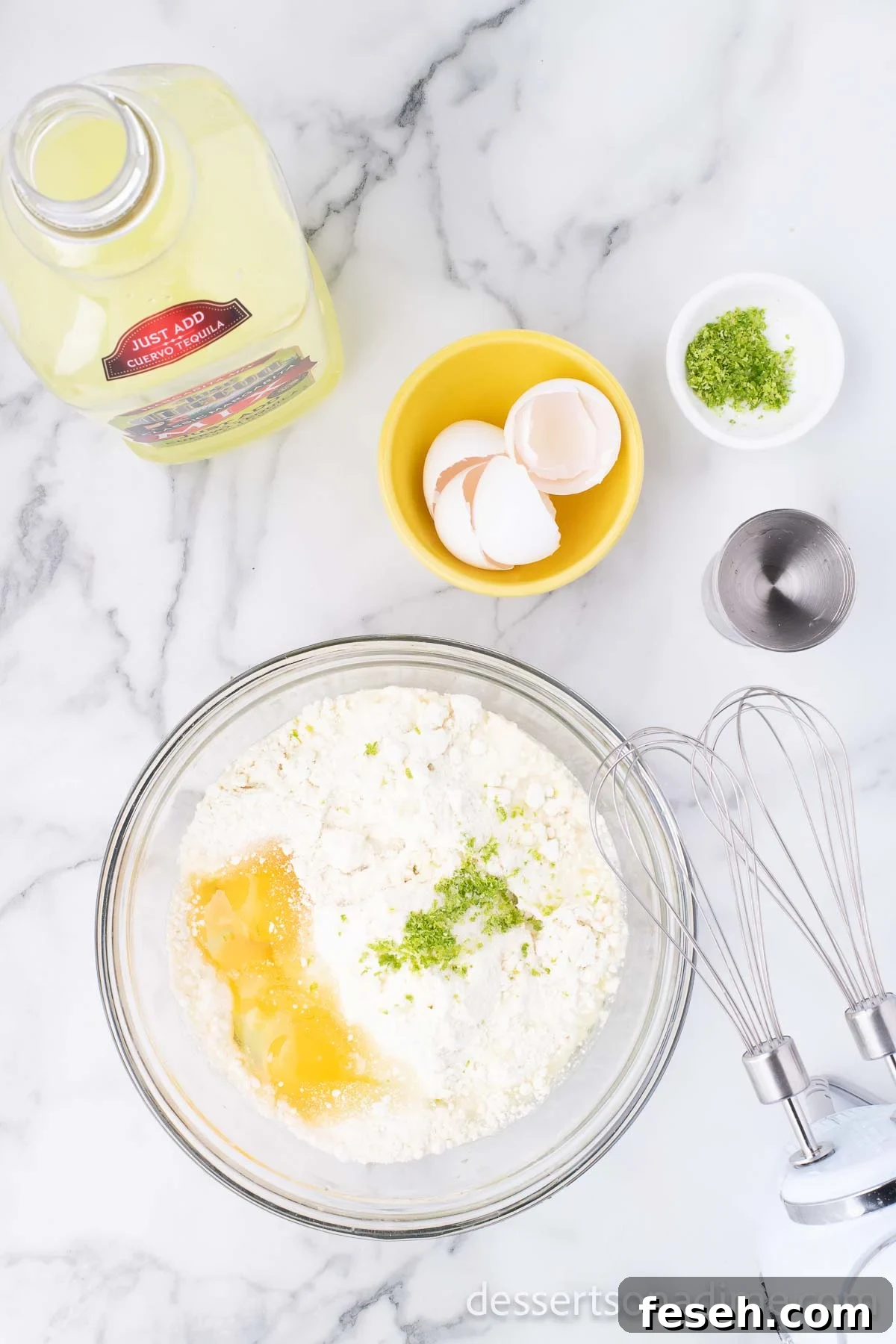 Margarita Poke Cake Recipe with Lime and Tequila 4 Mixing bowl with cake mix, margarita mix and eggs.