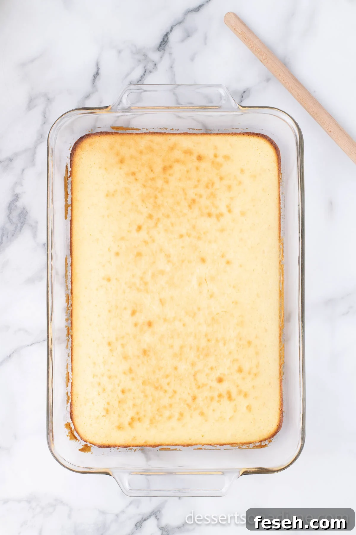 Margarita Poke Cake Recipe with Lime and Tequila 5 Cake in pan baked and cooling.