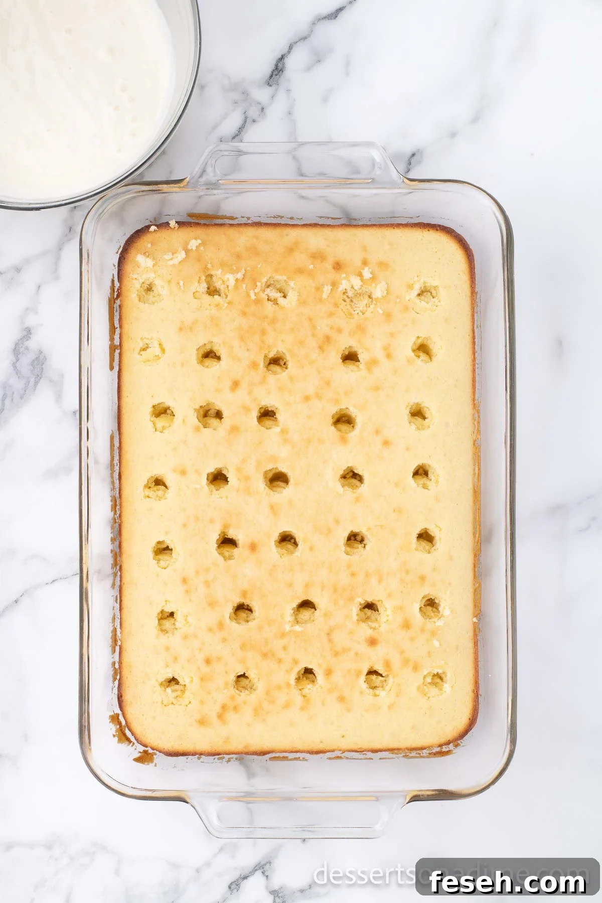 Margarita Poke Cake Recipe with Lime and Tequila 6 Cake with holes poked all over.