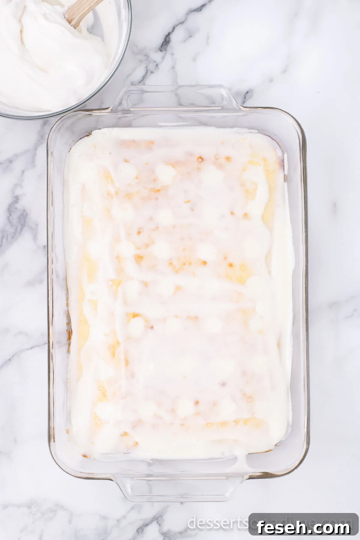 Margarita Poke Cake Recipe with Lime and Tequila 7 Filling poured over the cake.