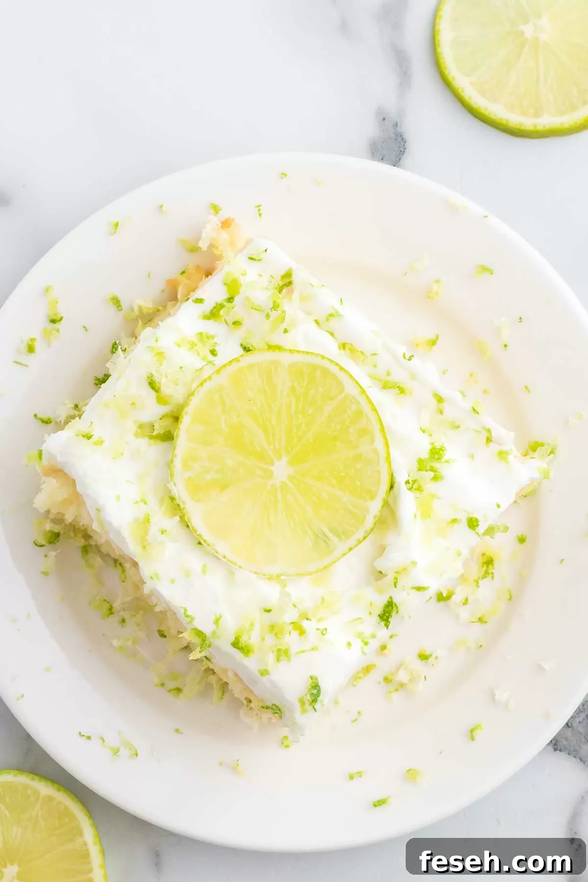 Margarita Poke Cake Recipe with Lime and Tequila 9 Cake sliced and served on plate.