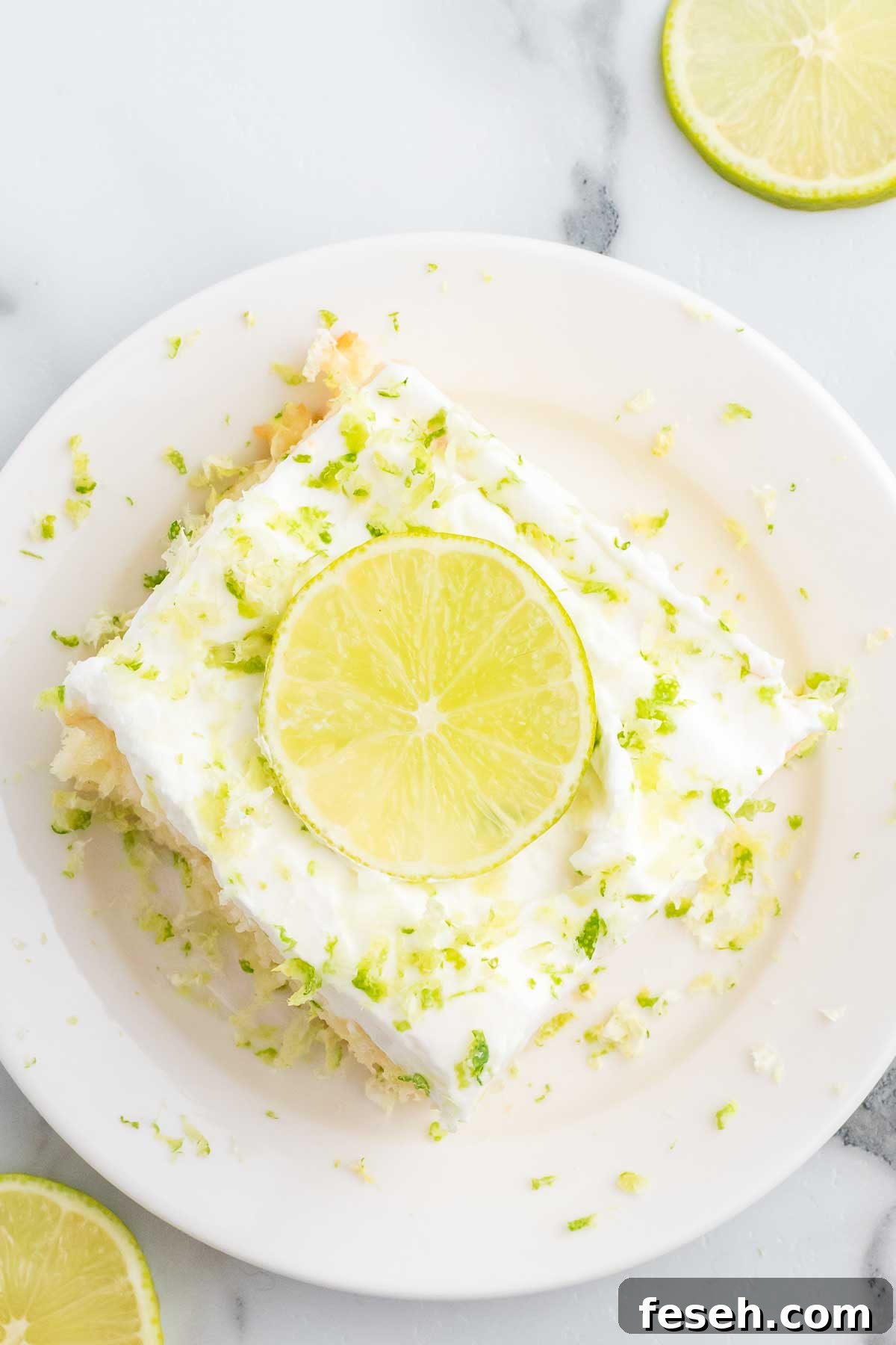 Margarita Poke Cake Recipe with Lime and Tequila 10 Slice of margarita poke cake on a plate.