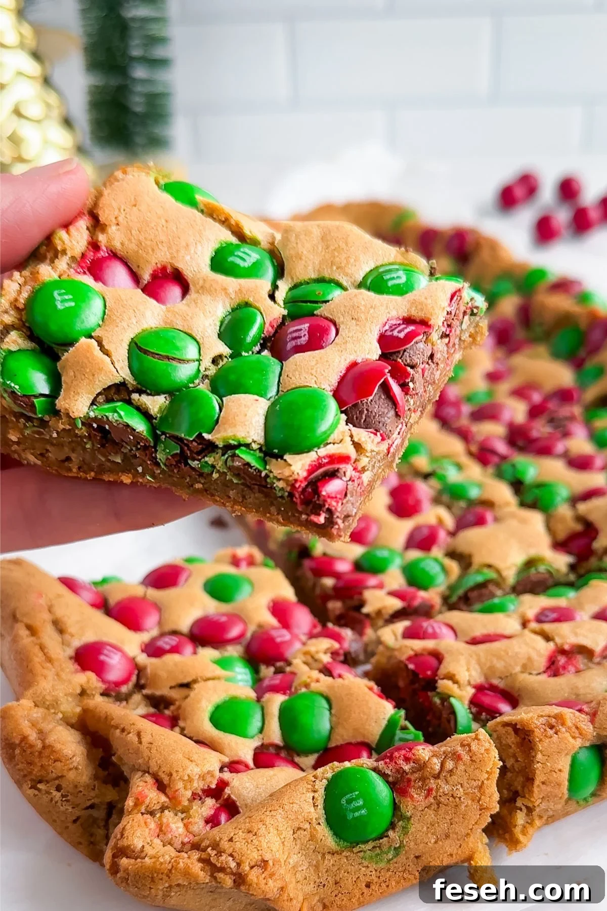 Holding a baked Christmas Dessert bar. 