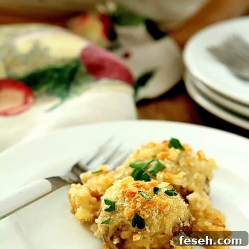 Serving of Baked Mushrooms on a White Plate. Mushrooms are baked in a Parmesan Cream Sauce.