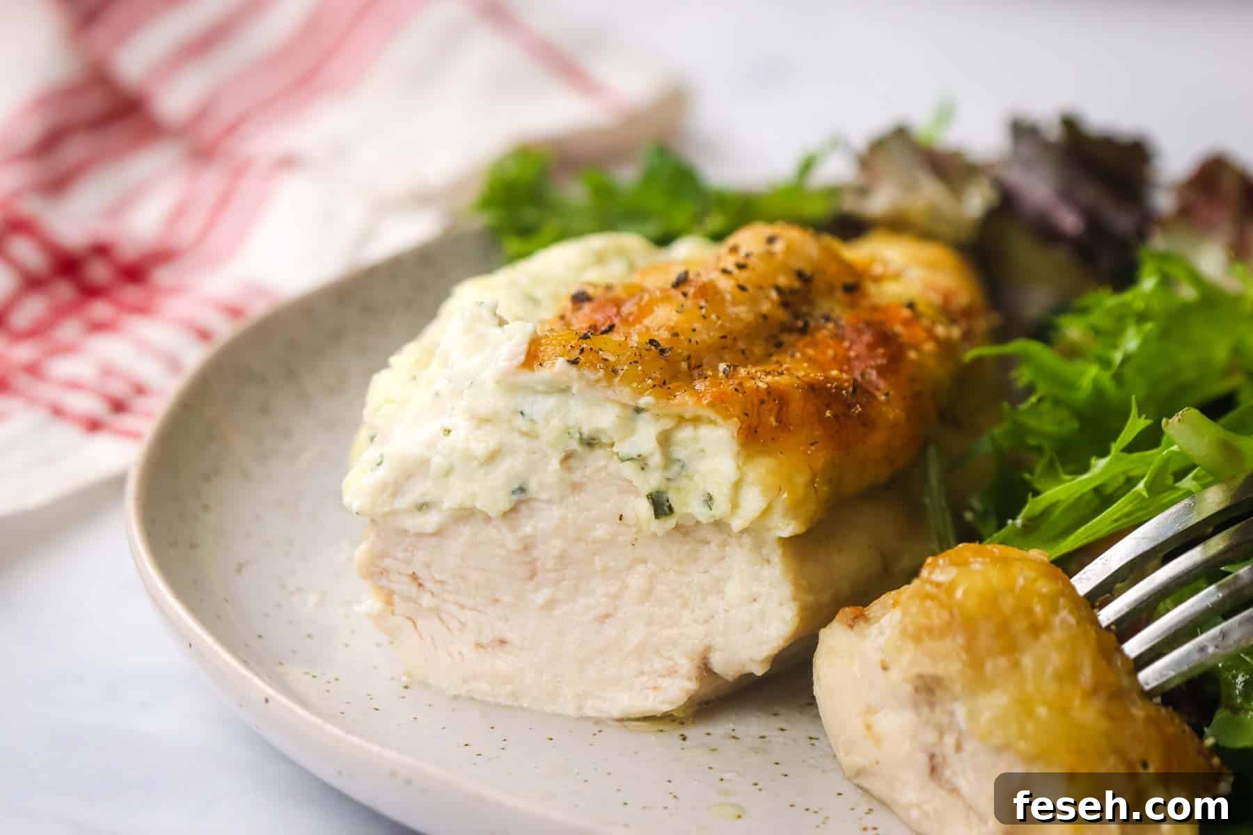 boursin chicken served in a plate with a simple side salad