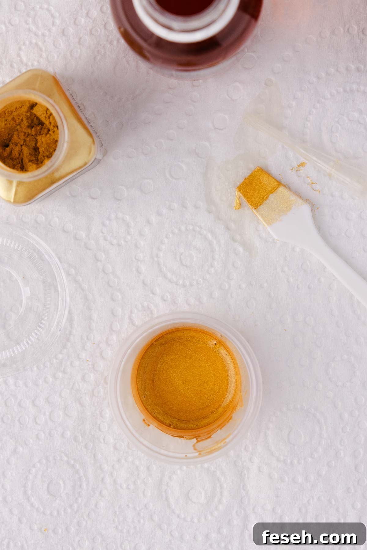 Close up of a small container of finished gold paint.