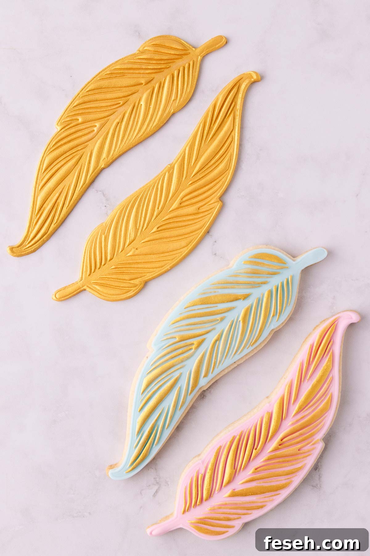 Gold painted feather fondant shapes and painted cookies.