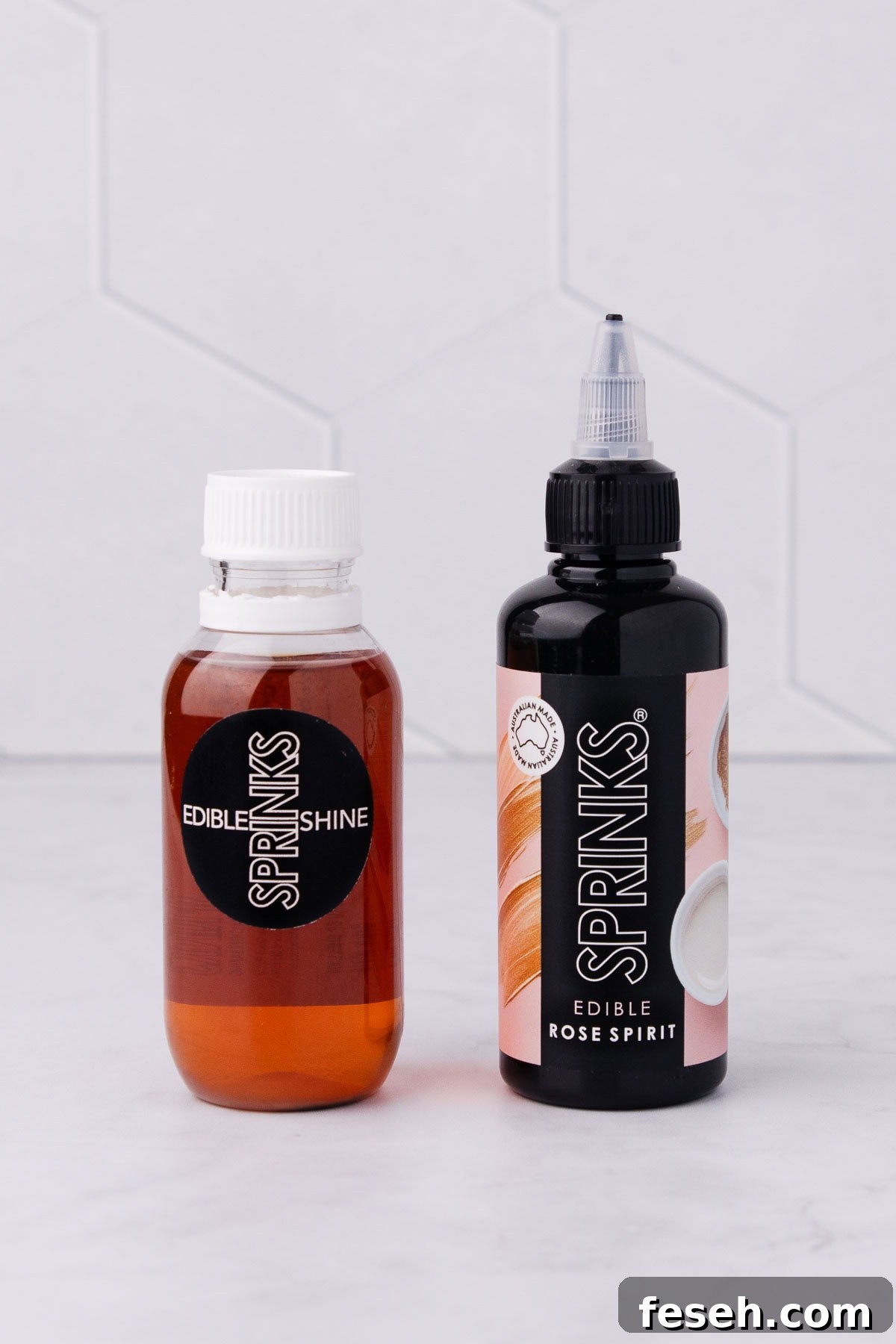 A bottle of Confectioner's glaze and rose spirit on a grey marble background.