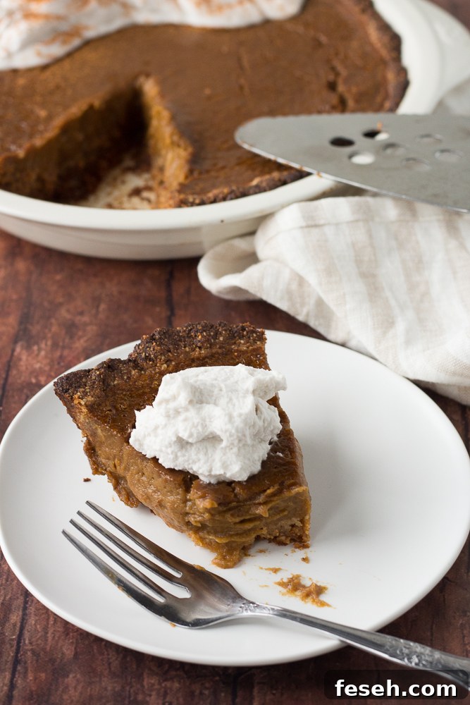 butternut squash pie topped with whipped cream on plate