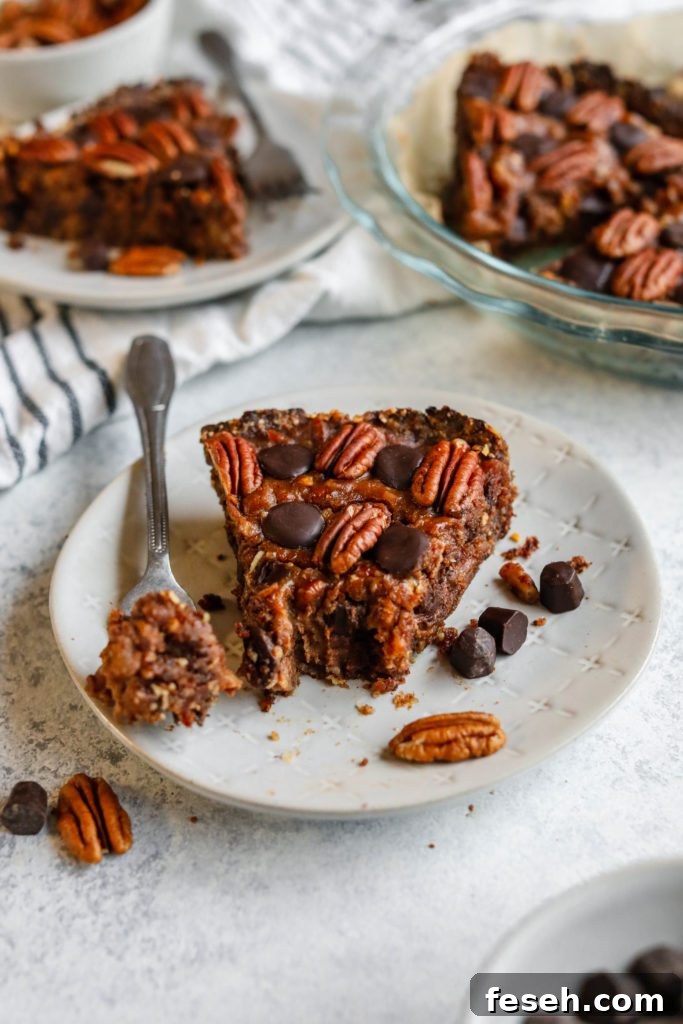 chocolate pecan pie with forkful on plate