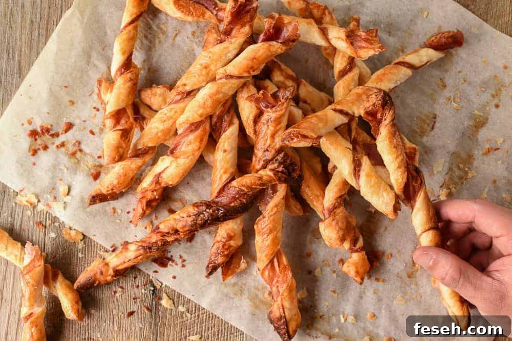 pile of pastry sticks with hand reaching in to take one.